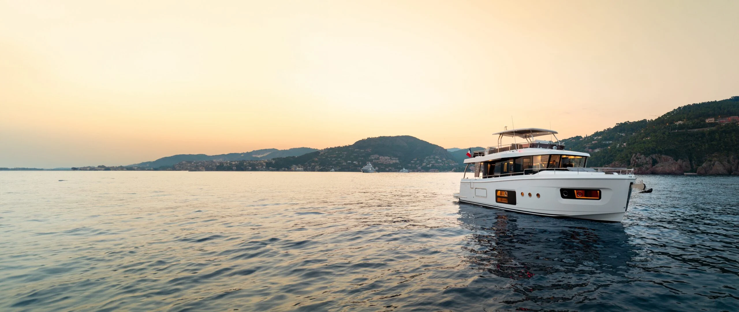 A yacht from Yacht Management’s sales showcase, centred in the sunset view